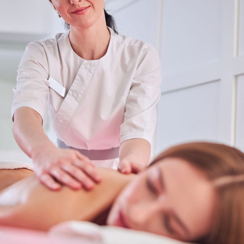 Massage Therapist In White Uniform Making Spa Trea XFTM49X